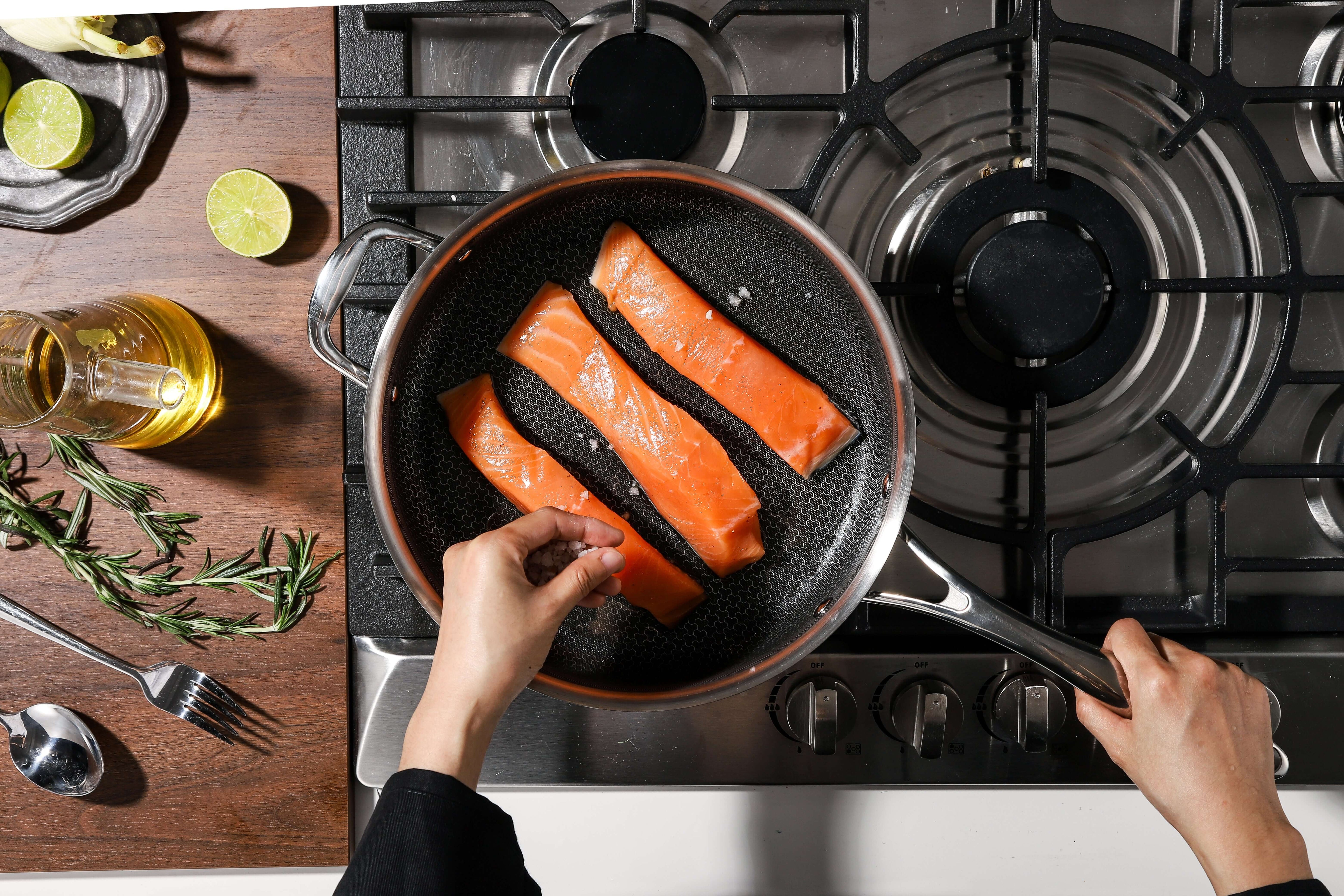Salmon fillets cooking in Deluxe ceramic sauté pan with ergonomic handle